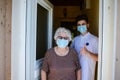 Young medic helping and old eldery woman to walk wear mask covid19 Royalty Free Stock Photo