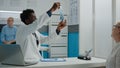 Young medic receiving x ray on desk from nurse