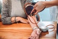 Young medic taking blood pressure during home visit, cl Royalty Free Stock Photo