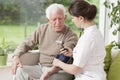 Young medic taking blood pressure Royalty Free Stock Photo