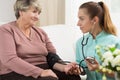 Young medic taking blood pressure Royalty Free Stock Photo