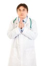 Young medical doctor praying for success