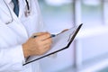 Young medical doctor with a stethoscope around his neck holding a black folder Royalty Free Stock Photo