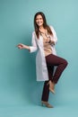 Young medical doctor woman presenting and showing copy space for product or text. Caucasian female medical professional Royalty Free Stock Photo