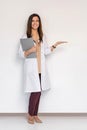 Young medical doctor woman presenting and showing copy space for product or text. Caucasian female medical professional Royalty Free Stock Photo