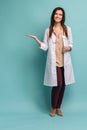 Young medical doctor woman presenting and showing copy space for product or text. Caucasian female medical professional Royalty Free Stock Photo