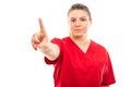 Young medical nurse wearing red scrub showing denying gesture