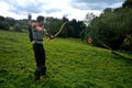 Young medieval archer with chain shirt, bow and arrow in nature during sheet tensioning Royalty Free Stock Photo