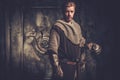 Young medieval knight posing on dark background. Royalty Free Stock Photo