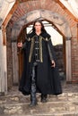Young medieval prince with saber and black mantle Royalty Free Stock Photo