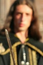 Young medieval prince with saber and black mantle Royalty Free Stock Photo