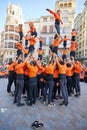Young members of moixiganga group forming human tower on the street festival in Valencia