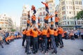 Young members of moixiganga group forming human tower on the street festival in Valencia