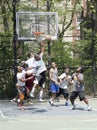 Young men in action playing basketball in the street