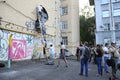 Young men activists set the poster portrait of famous Ukrainian poet and dissident Vasyl Stus on the wall of the