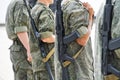 Young men armed with automatic weapons, in protective khaki clothes on the streets of the city. Patrol or security