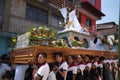 Young men carrying a heavy Easter float in Guatemala