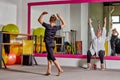 A young man dances under the supervision of a teacher. Sports lifestyle.