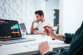 Group of coworkers looking at computer monitor while working in office