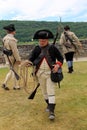 Interesting scene of several men dressed as soldiers demonstrating weapons, seen at war reenactment, Fort Ticonderoga, NY, 2016