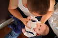 Young man feeding milk his baby boy son from bottle, view from above Royalty Free Stock Photo