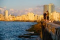 Young men fishing in Havana at sunset