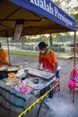 Young men frying Youtiao or Cakoi, a long golden-brown deep-fried strip of dough commonly. On a fresh market in Malaysia open air