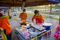 Young men frying Youtiao or Cakoi, a long golden-brown deep-fried strip of dough commonly. On a fresh market in Malaysia open air