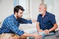 Young men health care elderly uncle in the home, old man pain at knee leg