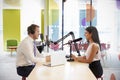 Young man interviewing a woman for a podcast