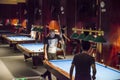 Young men play billiards