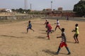 Young men playing soccer in a dirt field in the city of Bissau, in Guinea-Bissau