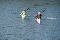 Young men practicing canoeing riding in canoe navigating the Jerte river, Spain