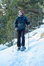 Young Men practicing snowshoes on winter trail in incredible sunny day in winter in the Pyrenees in Andorra