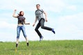 Couple of lovers jumping on meadow Royalty Free Stock Photo