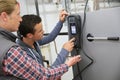 Young men in professional training controlling heat pump