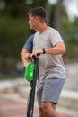 Young men riding rental scooters on Las Olas Riverwalk Royalty Free Stock Photo