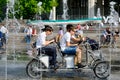 Young men riding velomobile.