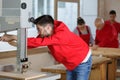 Young man setting up woodworking machine Royalty Free Stock Photo