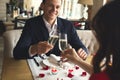 Young couple having romantic dinner in the restaurant drinking champagne cheers filter Royalty Free Stock Photo