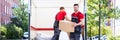 Young Men Stacking The Cardboard Boxes In Moving Truck Royalty Free Stock Photo