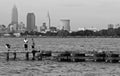 Young men stand on a pier looking at Downtown Cleveland, Ohio