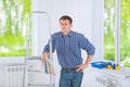 A young men standing near the stepladder holding color palette a Royalty Free Stock Photo