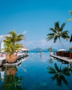 Young men in swimming pool during sunset, Luxury swimming pool in tropical resort, relaxing holidays in Seychelles Royalty Free Stock Photo