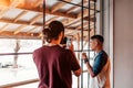 Young man takes a picture of his arabian friend. Best friends spending time in cafe.