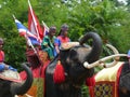 Young Men in Thai Ancient Costumes riding an Elephant