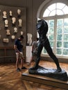 Young men tourists study statues and busts in the Rodin Museum, Paris, France