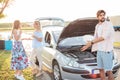 Young man trying to repair a broken car