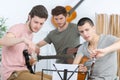 Young men tuning their guitars for rehearsal Royalty Free Stock Photo