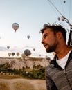 Young men on vacation Cappadocia Turkey sunrise in the hills with hot air balloons, Kapadokya Beautiful vibrant colorful Royalty Free Stock Photo